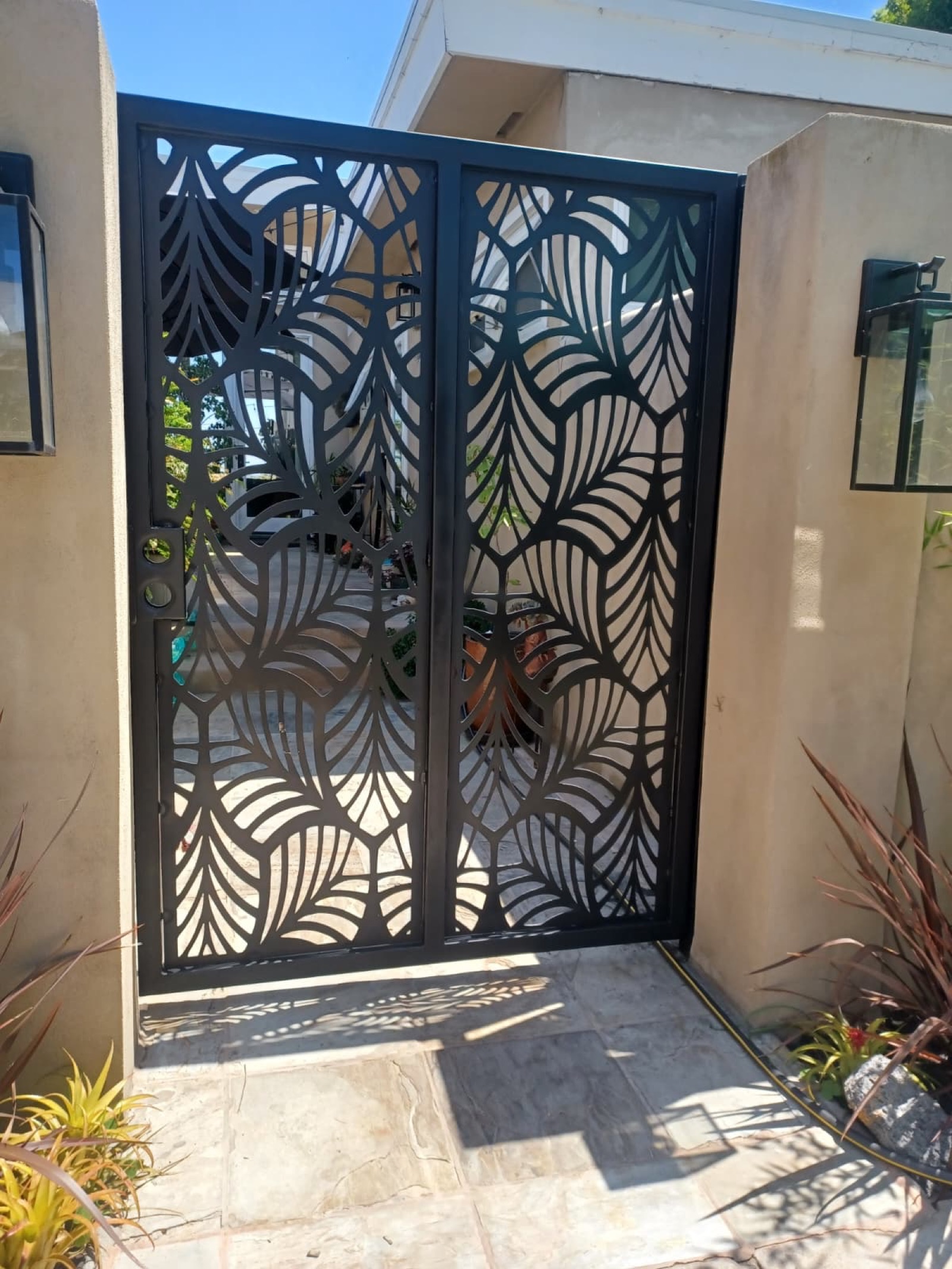 Custom black leaf-pattern metal gate by Alex Iron Works